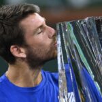 Cameron Norrie (GBR) holds the championship trophy after defeating Nikoloz Basilashvili (GEO) in the men's final in the BNP Paribas Open at the Indian Wells Tennis Garden.