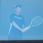 A tennis player practices with a racket inside a room at a hotel where players are undergoing mandatory quarantine in advance of the Australian Open in Melbourne, Australia, January 21, 2021