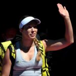 Danielle Collins of the U.S. waves at fans at the 2022 Australian Open