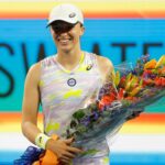 Iga Swiatek (POL) is presented a bouquet for becoming the number one women's player in the world after her victory over Victorija Golubic (SUI) (not pictured) in a second round women's singles match in the Miami Open at Hard Rock Stadium.