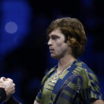 Andrey Rublev shakes hands with Stefanos Tsitsipas after winning their group stage match at the 2022 ATP Finals