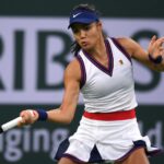 Emma Raducanu (GBR) hits a shot against Aliaksandra Sasnovich (BLR) at Indian Wells Tennis Garden.