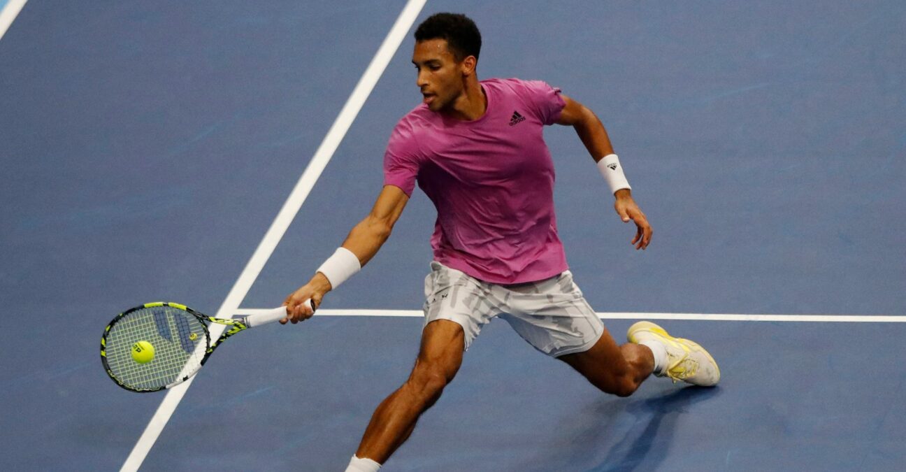 Felix Auger Aliassime hits a forehand close to the net in Basel in 2022